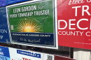 broken glass in front of campaign posters 