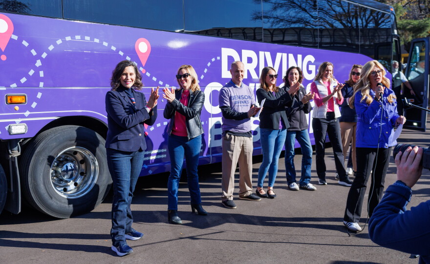 Gov. Gretchen Whitmer, left, and Democratic gubernatorial nominee Jocelyn Benson, right, during the first stop on Benson's statewide "Driving Down Costs" bus tour in East Lansing, Mich., on Oct. 22, 2026.