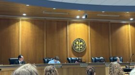 The Alachua City Commission during Monday’s meeting. Rodolfo Valladares (far left) sits next to Commissioner Jacob Fletcher. (Jordan Costagliola/WUFT News)