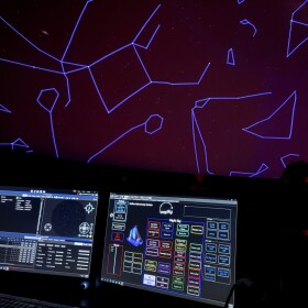 a computer screen in the planetarium projects constellations onto the ceiling
