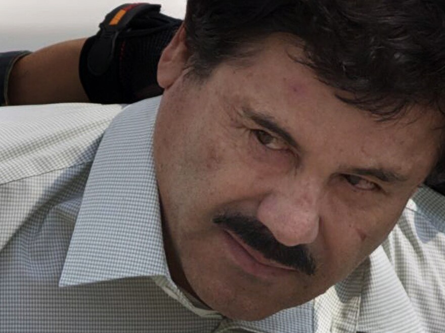 Joaquin "El Chapo" Guzman is escorted to a helicopter in handcuffs by Mexican navy marines at a navy hanger in Mexico City after his capture last year. Guzman escaped from a maximum security prison for the second time this July; today, Mexican authorities announced he evaded an attempt to recapture him.