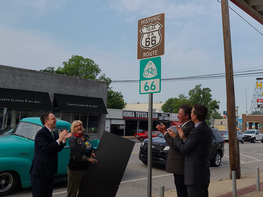  From left to right: Tulsa Mayor G.T. Bynum, Buck Atom's owner Mary Beth Babcock, Oklahoma Lieutenant Governor Matt Pinnell and Oklahoma Secretary of Transportation Tim Gatz celebrate after unveiling the first U.S. Bike Route 66 road sign.  