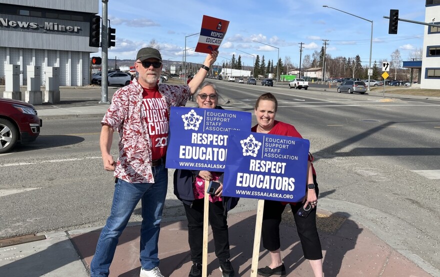 Picketers from the Education Support Staff Association and Fairbanks Education Association wave to traffic at the intersection near the Juanita Helms Administrative Center where the FNSB Assembly was holding budget hearings on May 4.