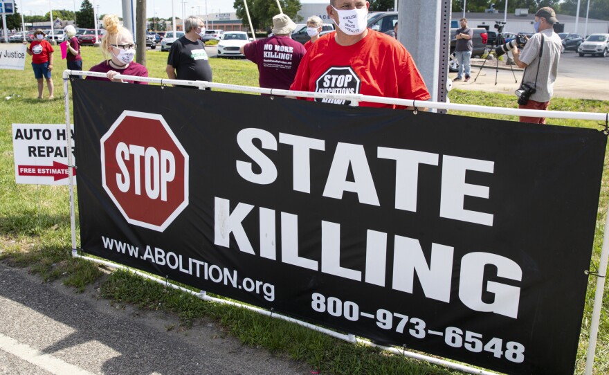 Protesters against the death penalty gather in Terre Haute, Ind., on Monday. Daniel Lee, a convicted killer, was executed the following morning after court rulings cleared the way.