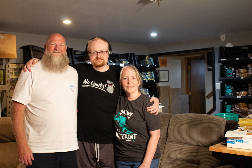 Trent Landreth (middle) is the creator behind Drawings by Trent. His mother (right) and father (left) help with him record his viral drawing videos and manage his business.