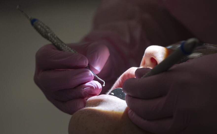 Tycee Thivierge works on a patient's teeth through part of an NIC training program on Thursday, Oct. 1 at 450 11th Ave in Lewiston.