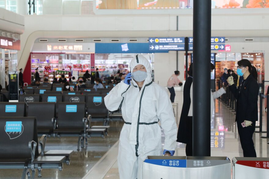With rising concerns that the movements of asymptomatic carriers could lead to a second wave of infection, travelers remain vigilant about wearing protective gear at the Tianhe Airport in Wuhan.