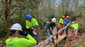 Carolina Mountain Club volunteers build a bridge during the group's Quarterly Crew Day in April 2024.
