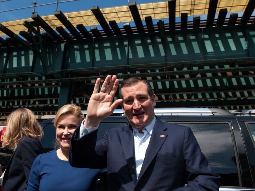 Standing in front of elevated subway tracks, Republican presidential hopeful Ted Cruz waves, as he arrives at the Sabrosura 2 restaurant in The Bronx, N.Y. April 6.