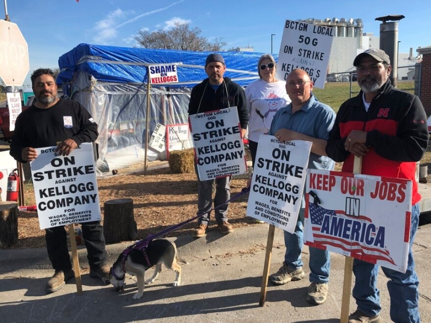 Striking Kellogg's workers stand outside the Omaha, Neb., cereal plant on, Dec. 2. The company reached a new tentative agreement on Thursday, with its 1,400 cereal plant workers that could bring an end to the strike that began Oct. 5.
