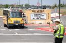 A school bus approaches a sheriff deputy at Bulverde Middle School on Monday, March 30, 2026. Students at Hill Country College Preparatory High School were evacuated to the middle school Monday after one of their classmates shot and injured a teacher. The student then turned the gun on himself and died on the scene, according to law enforcement.
