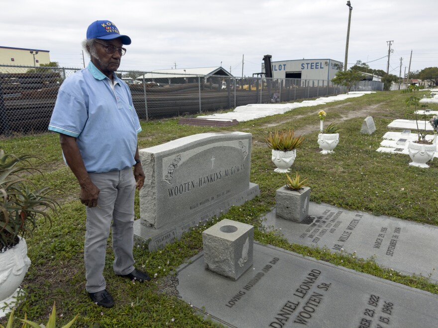 Elijah Wooten stands near the graves of many of his family members at the Westview Community Cemetery.