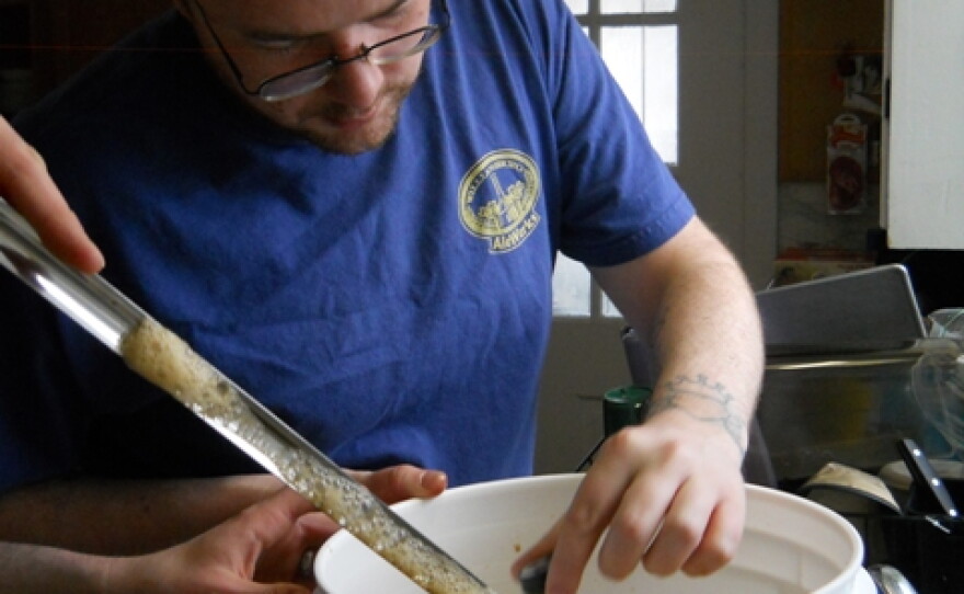 SCBC President Owen McLaughlan checks the temperature of a just-brewed stout.