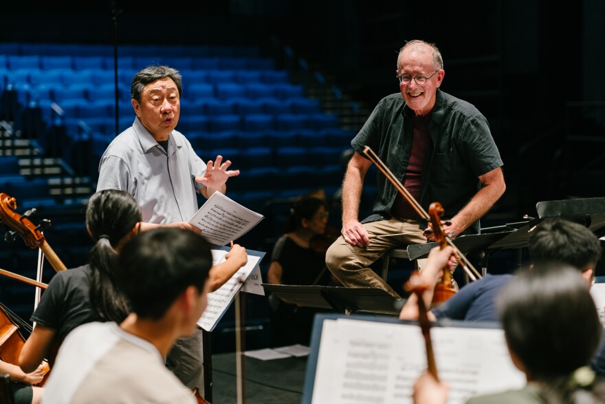 Faculty member Li-Kuo Chang, assistant principal viola of the @Chicago Symphony Orchestra, and Orchestra Director James Ross offer feedback to the NYO2 musicians.