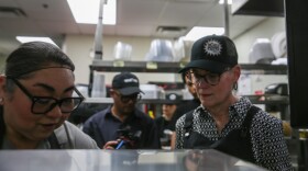 Hobbs learns how to prepare a tortilla in the Chile Pepper kitchen.