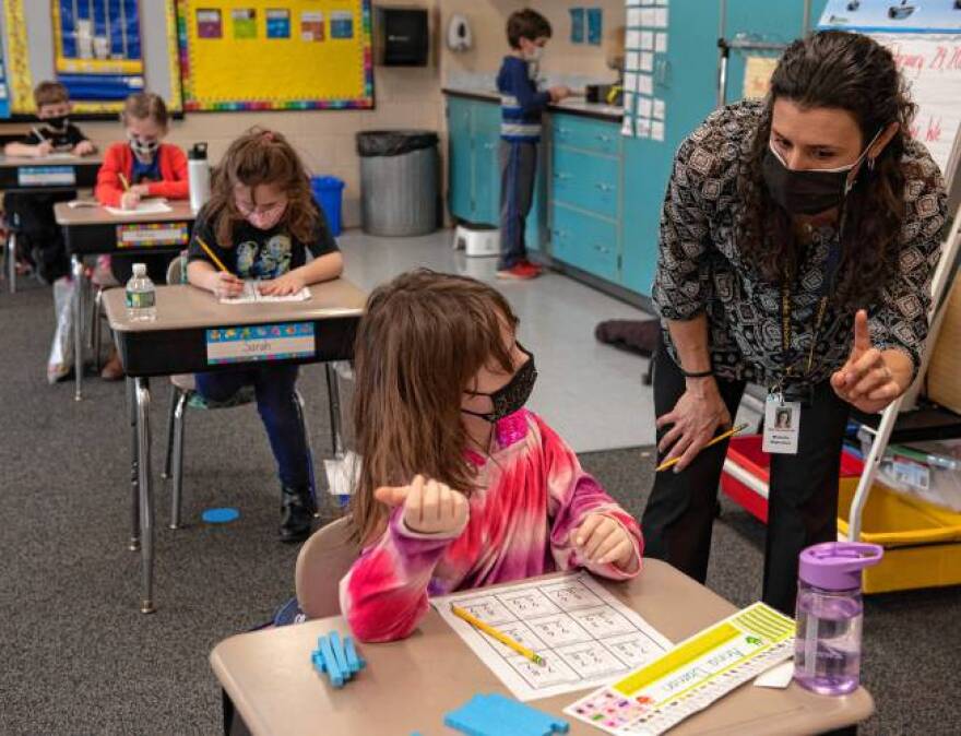 Michelle Wojtowicz, a teacher at Hadley Elementary School, helps Anna Damon during class on Feb. 24, 2021.