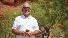 Washington County Water Conservancy District Conservation Manager Doug Bennett stands beside some shade-giving trees at the Red Hills Desert Garden in St. George, Aug. 20, 2026.