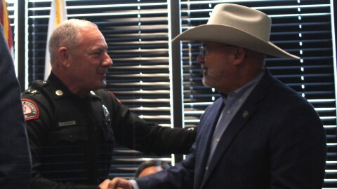 Interim Greene County Sheriff Jason Johnson shakes hands with former Greene County Sheriff Jim Arnott.