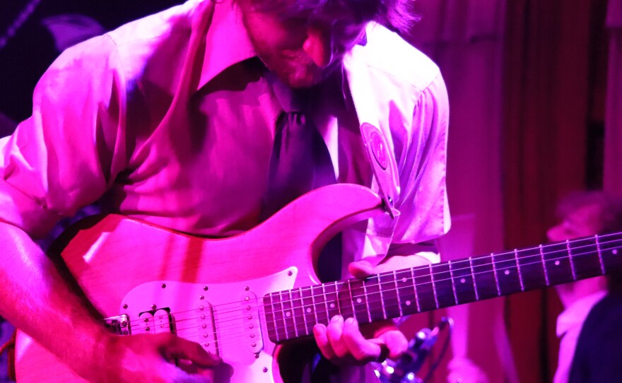 A close-up of a guitarist playing.