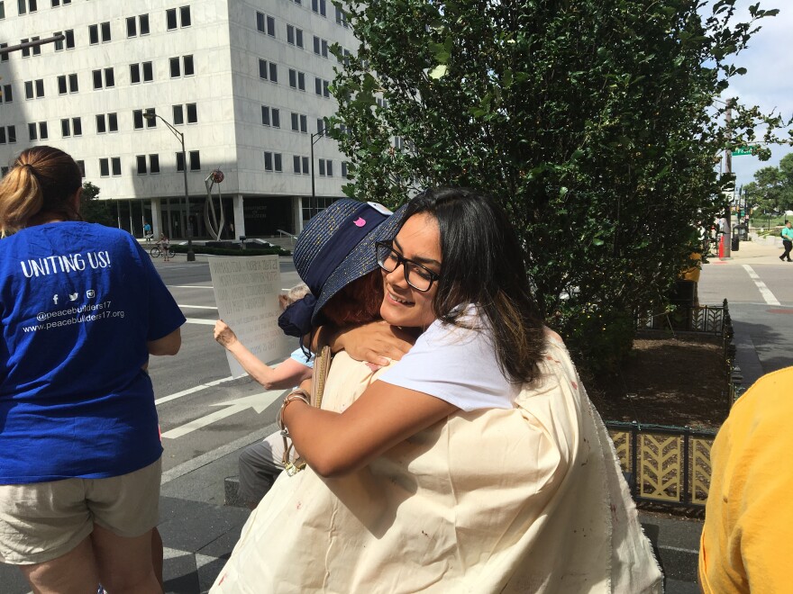 A volunteer hugs woman who has meeting with ICE 