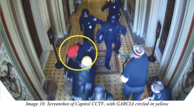 A screen grab included in the FBI affidavit shows a man in a red hat alleged to be August Garcia of Laramie.