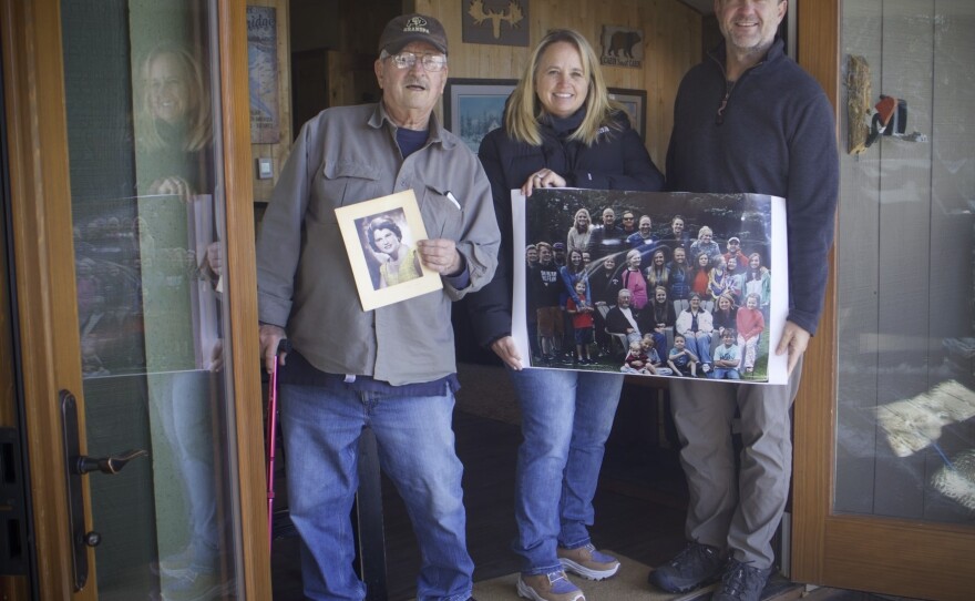 Robert Zawacki, from left, Laura James and Jesse James, her husband, hold up a picture of their larger family on Wednesday, Feb. 28, 2024. Zawacki, James’s father, built the home in the 1970s alongside her mother, who died after James and her husband purchased the home from them. It’s remained in the family ever since. “Not only was this the cabin that my siblings and I were raised in,” but also the current generation, James said.