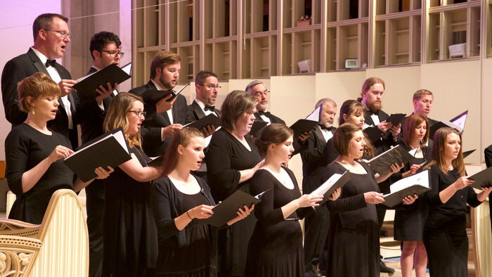 The Critical Mass Vocal Artists sing at a concert.