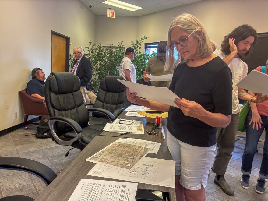 Local resident Martha Stafford reviews substation site plans at a meeting on Monday, May 4, 2026.