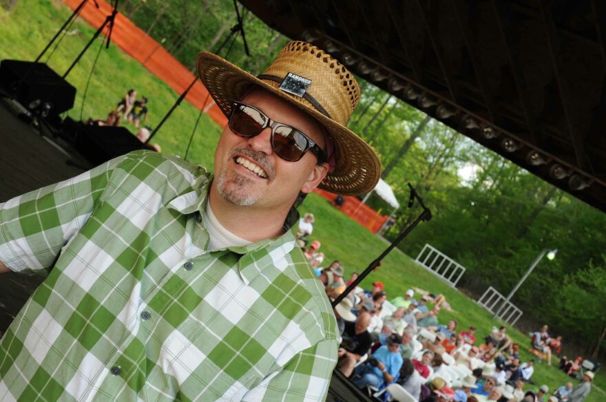 image of man in hat smiling wearing sunglasses