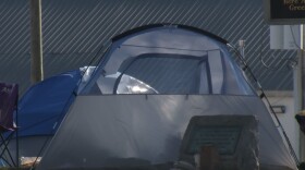 A photo of a tent set up in Bloomington's Seminary Park.
