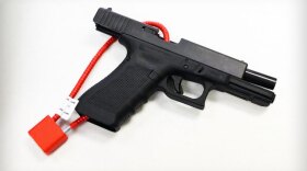 A firearm with a cable lock attached