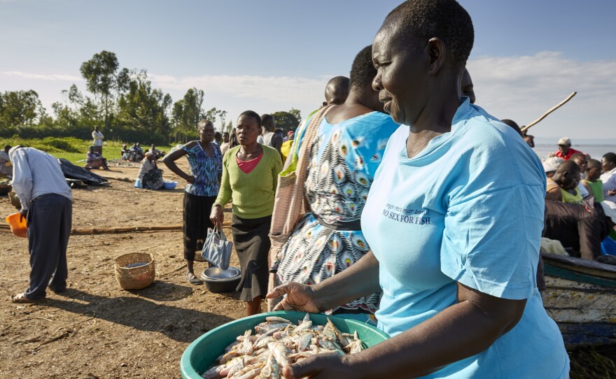 In her "No Sex For Fish" T-shirt, Justine Adhiambo Obura joins other traders who take fish from the day's catch to sell at the market.