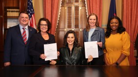 Michigan Governor Gretchen Whitmer poses with legislative leaders after signing the state budget.