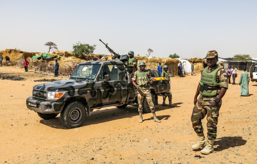 Soldiers patrol the sprawling Assaga refugee camp, which is home to thousands of people uprooted from their homes by Boko Haram attacks on both sides of the Nigeria-Niger border.