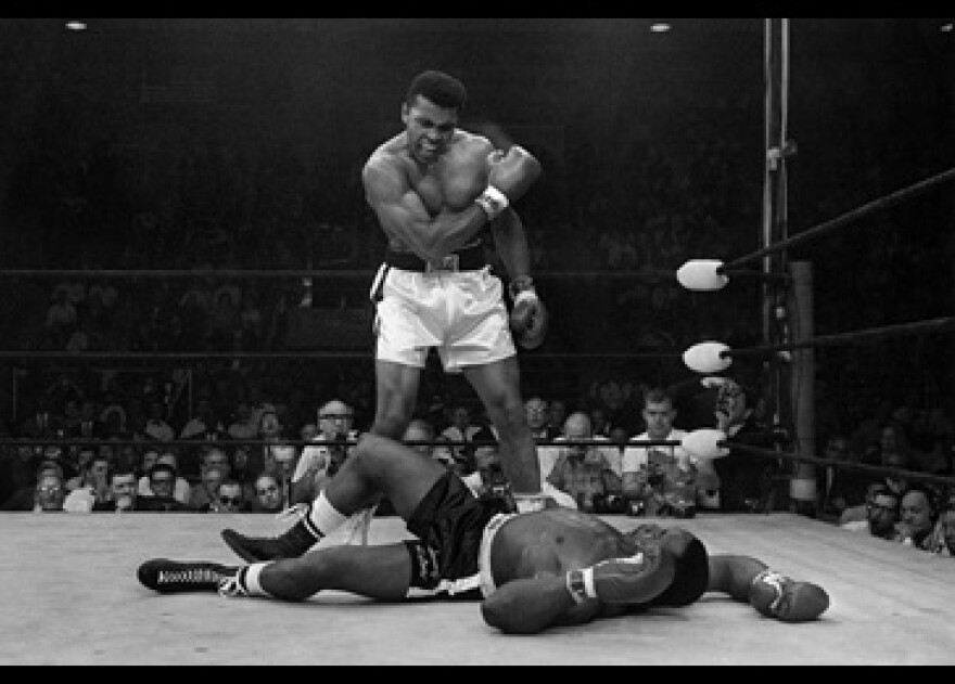 Muhammad Ali stands over fallen Sonny Liston, shouting and gesturing shortly after dropping Liston with a short hard right to the jaw in Lewiston, Maine. May 25, 1965.