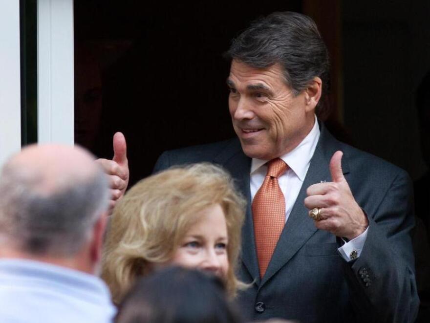 Texas Gov. and Republican presidential hopeful Rick Perry gives a thumbs up as he arrives at a campaign event at the home of New Hampshire State Rep. Pam Tucker on August 13, 2011 in Greenland, New Hampshire.