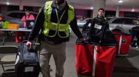 Members of the Luzerne County sheriff's department unload voting machines at Penn Place in Wilkes-Barre.