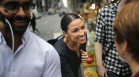 Alexandria Ocasio-Cortez greets a reporter near Rockefeller Center in New York Wednesday, a day after the 28-year-old political newcomer upset U.S. Rep. Joe Crowley in New York's Democratic primary.