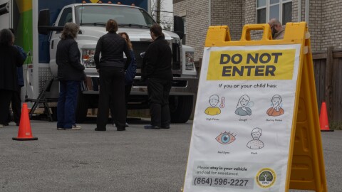 South Carolina Department of Public Health staff stand in front of an agency Mobile Health Unit in Spartanburg.