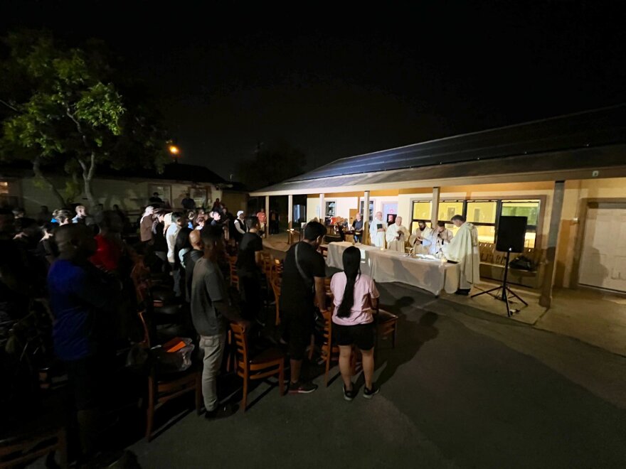 Bishop E Flores of the Brownsville Catholic Diocese leads a Mass with local clergy at Ozanam migrant shelter where several migrants lost their lives on Sunday.