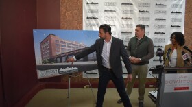Developer Casey Baldovin shows his vision for the buildings he purchased on SW Adams. Councilman Sid Ruckriegel and Councilwoman Denise Moore look on.