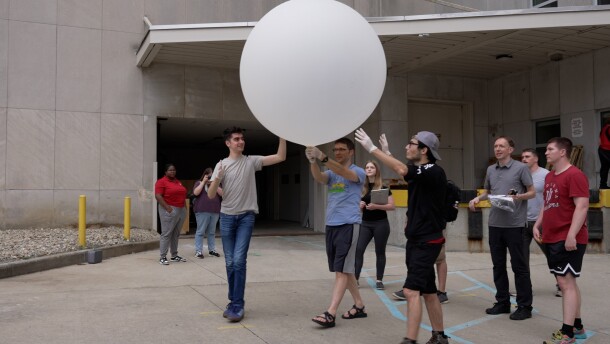 Students and faculty prepare to launch the weather balloon Thursday evening on campus.
