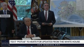 three guys in the Oval Office, by a map of Alaska