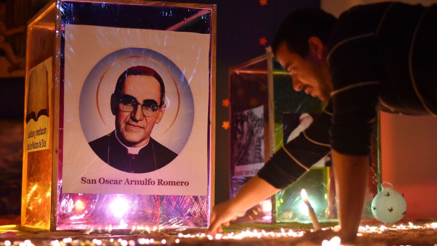 A man lights a candle in Ciudad Barrios, the hometown of blessed Monsignor Oscar Romero, some 165 kilometres from San Salvador, to mark his canonization Sunday.