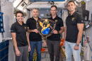 The four members of NASA’s SpaceX Crew-13 mission to the International Space Station display their mission plaque inside a training mockup of a space station module. From left are, Commander Jessica Watkins and Pilot Luke Delaney, both from NASA, and Mission Specialists Joshua Kutryk of CSA (Canadian Space Agency) and Sergey Teteryatnikov of Roscosmos.