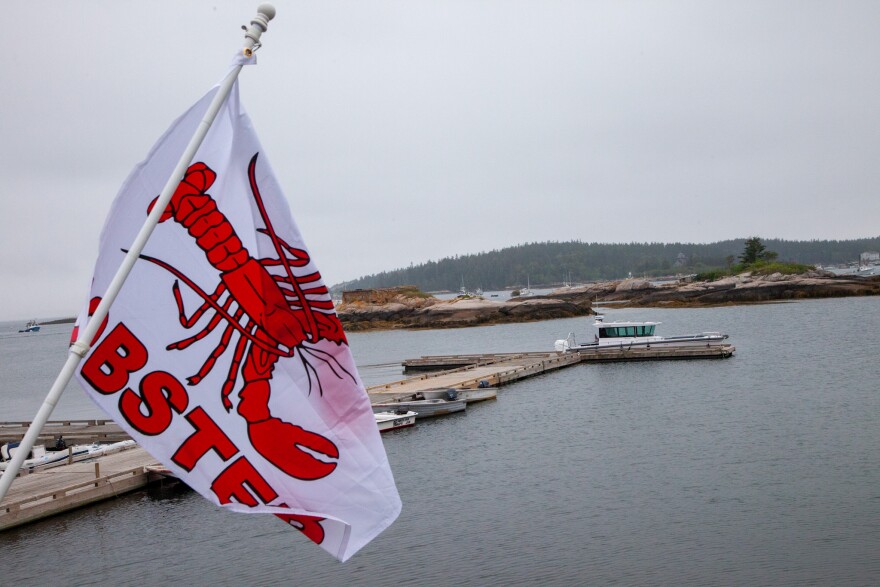 A lobster flag flies over the water in Stonington on July 8, 2025.