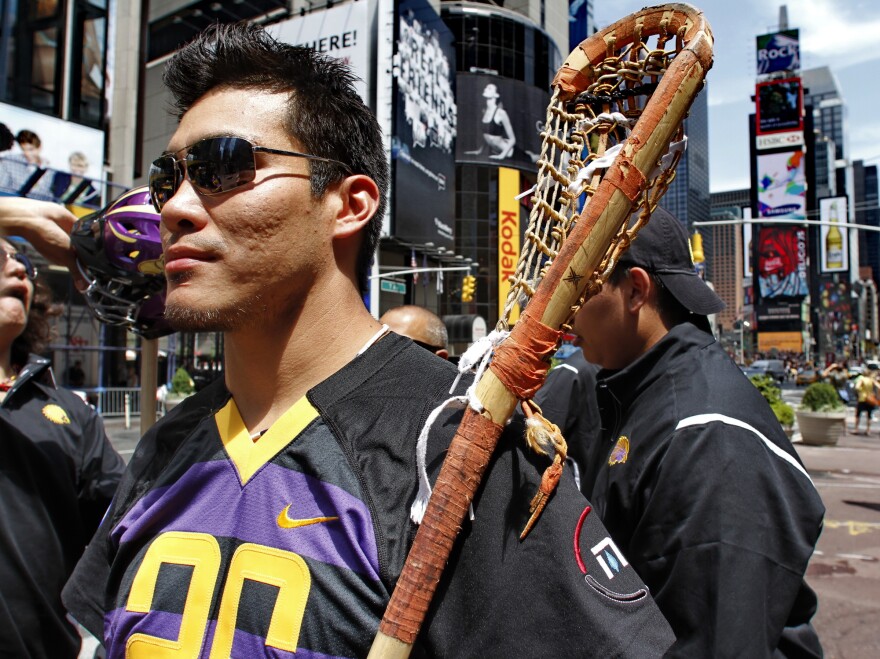 Brett Bucktooth, a member of the Iroquois Nationals Lacrosse team and Syracuse University's 2004 national championship team, visit Times Square, New York, Monday, July 12, 2010. The 23 players on the Iroquois Indian lacrosse team cannot fly to England for what's considered the Olympics of the sport because the U.S. government won't allow them to re-enter the country on Iroquois nation passports. "This is a world championship. I am hoping there is a resolution to this problem quickly," said Bucktooth. (AP Photo/Bebeto Matthews)