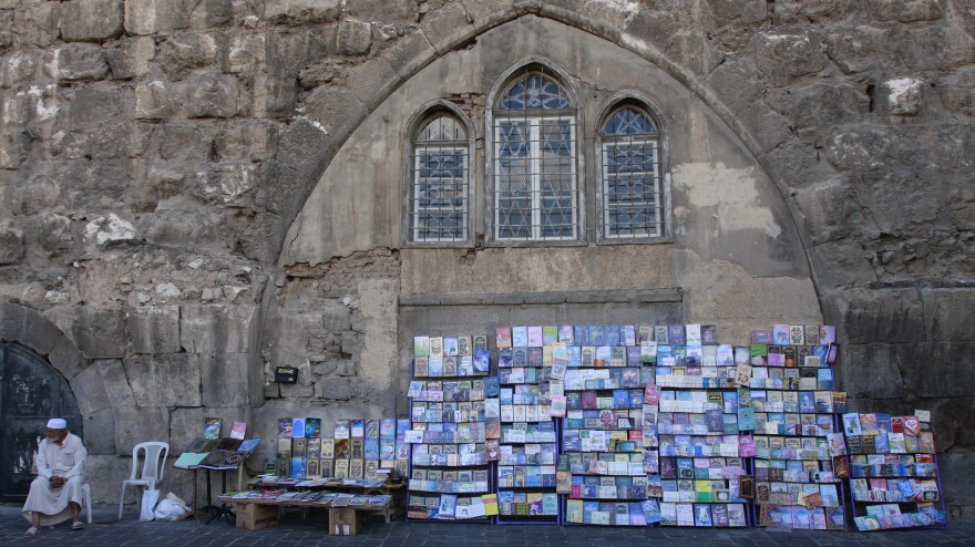 A Syrian book vendor waits for customers at his street stall in the old city of Damascus, Syria, on Sept. 24, 2011.