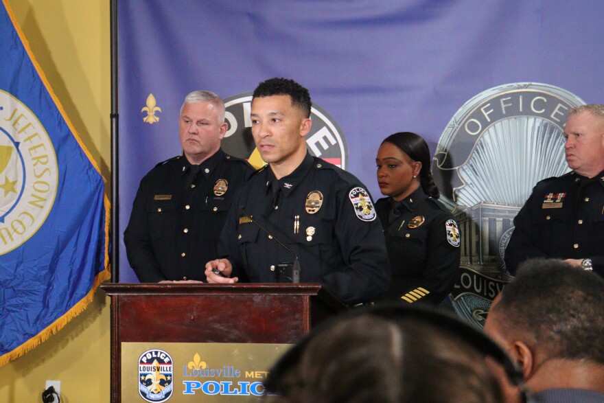 A police commander stands at podium.