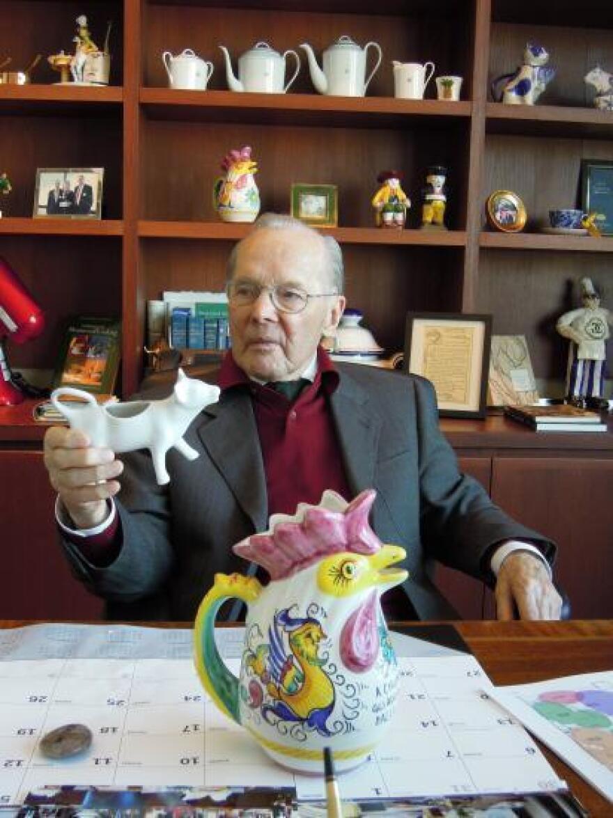 Chuck Williams in 2011 in his San Francisco office with a painted water pitcher in the form of a chicken and other items from his collection.